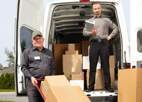 Removal team moving office items through a commercial building