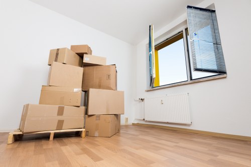 Relocation crew dismantling office furniture in Watford