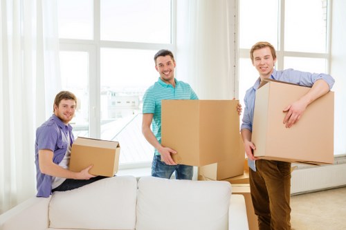 Packed moving boxes and wrapped furniture ready for removals in Watford